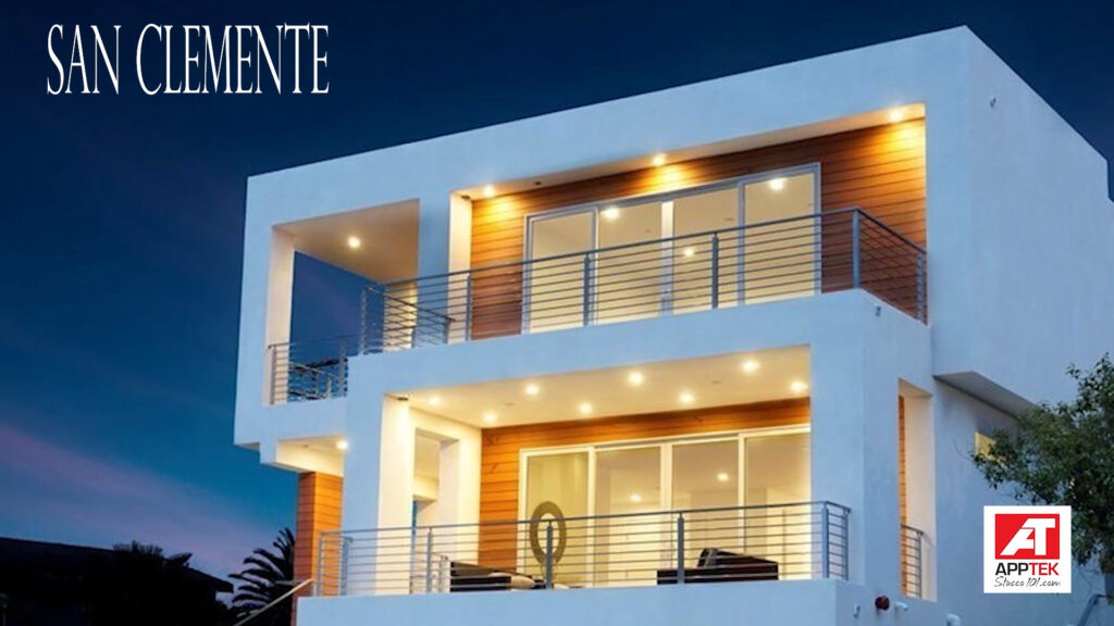 Modern luxury stucco home in San Clemente with illuminated exterior at night